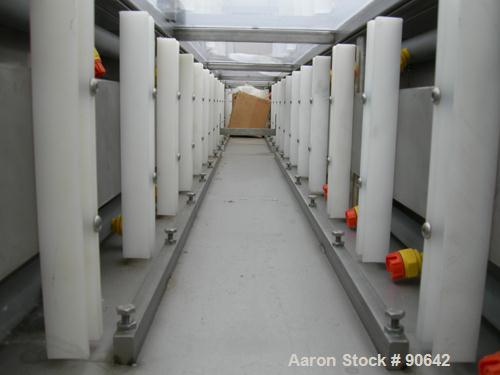 Used: Extrusion Services Inc.(ESI) spray cooling tank, 304 stainless steel. 16" wide x 11" deep x 20' long.(4) section top cover. Includes holding tank,pump, heat exchanger,and control panel. Mounted...
