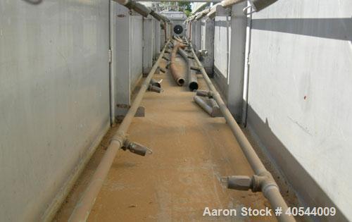 Used Gatto spray cooling tank, model WST105B21-2, 304 stainless steel. (4) compartment, 12" wide x 252" long x 12" deep. (4) piece top cover, (4) spray pipes with nozzles, 20' long. Mounted on a carb...