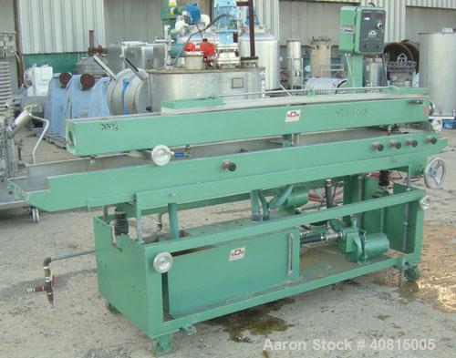 Used RDN Vacuum Sizing Tank, Model 20 P.V.S., 304 Stainless Steel.  6 1/2" wide x 6" deep x 96" long.  (1) 75" long section with cover.   Includes a holding tank, heat exchanger and pump.  Mounted on...