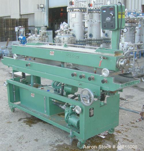 Used RDN Vacuum Sizing Tank, Model 20 P.V.S., 304 Stainless Steel.  6 1/2" wide x 6" deep x 96" long.  (1) 75" long section with cover.   Includes a holding tank, heat exchanger and pump.  Mounted on...
