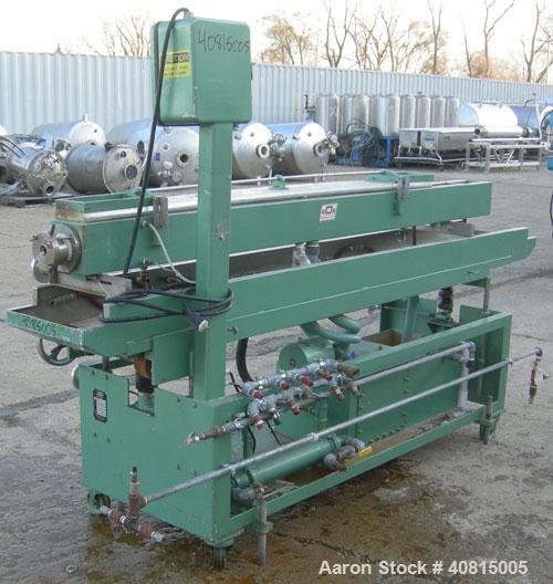 Used RDN Vacuum Sizing Tank, Model 20 P.V.S., 304 Stainless Steel.  6 1/2" wide x 6" deep x 96" long.  (1) 75" long section with cover.   Includes a holding tank, heat exchanger and pump.  Mounted on...