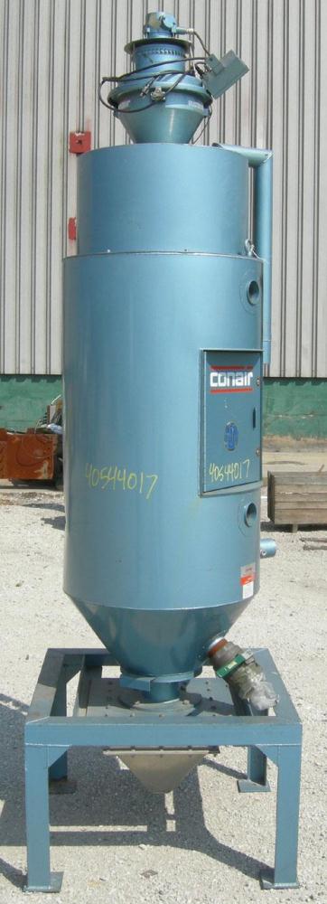 Used Conair insulated drying hopper, carbon steel, model 1805390300. 26" diameter x 46" straight side. Top mounted loader, side access door. Mounted on a frame.