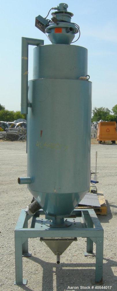 Used Conair insulated drying hopper, carbon steel, model 1805390300. 26" diameter x 46" straight side. Top mounted loader, side access door. Mounted on a frame.