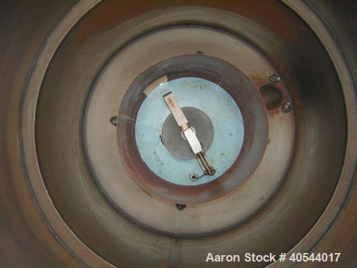 Used Conair insulated drying hopper, carbon steel, model 1805390300. 26" diameter x 46" straight side. Top mounted loader, side access door. Mounted on a frame.
