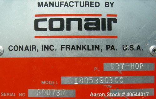 Used Conair insulated drying hopper, carbon steel, model 1805390300. 26" diameter x 46" straight side. Top mounted loader, side access door. Mounted on a frame.