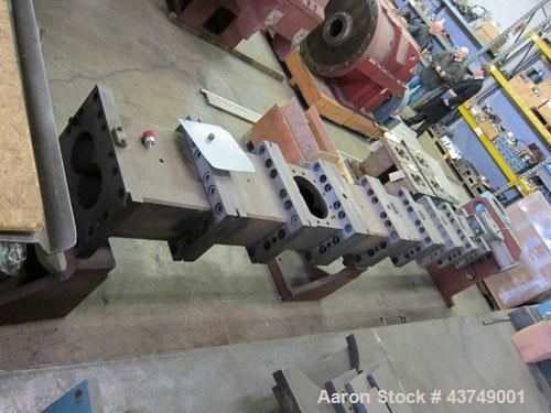 Used Werner Pfleiderer Twin Screw Gearboxes (3) and Thrust Bearing Assemblies.  Additional parts include one base for 160 mm.  Lot various barrels, heaters, shafts, screw elements and barrel supports.