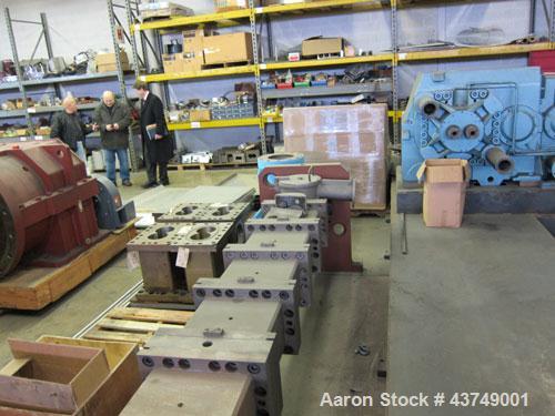 Used Werner Pfleiderer Twin Screw Gearboxes (3) and Thrust Bearing Assemblies.  Additional parts include one base for 160 mm.  Lot various barrels, heaters, shafts, screw elements and barrel supports.