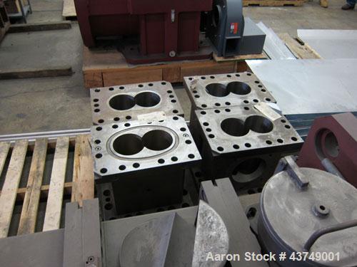 Used Werner Pfleiderer Twin Screw Gearboxes (3) and Thrust Bearing Assemblies.  Additional parts include one base for 160 mm.  Lot various barrels, heaters, shafts, screw elements and barrel supports.