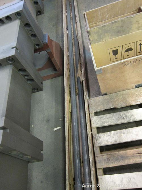 Used Werner Pfleiderer Twin Screw Gearboxes (3) and Thrust Bearing Assemblies.  Additional parts include one base for 160 mm.  Lot various barrels, heaters, shafts, screw elements and barrel supports.