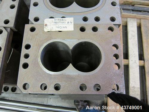 Used Werner Pfleiderer Twin Screw Gearboxes (3) and Thrust Bearing Assemblies.  Additional parts include one base for 160 mm.  Lot various barrels, heaters, shafts, screw elements and barrel supports.