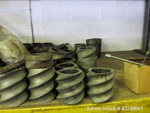 Used Werner Pfleiderer Twin Screw Gearboxes (3) and Thrust Bearing Assemblies.  Additional parts include one base for 160 mm.  Lot various barrels, heaters, shafts, screw elements and barrel supports.