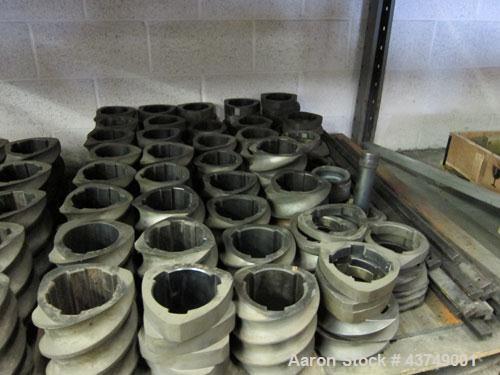 Used Werner Pfleiderer Twin Screw Gearboxes (3) and Thrust Bearing Assemblies.  Additional parts include one base for 160 mm.  Lot various barrels, heaters, shafts, screw elements and barrel supports.