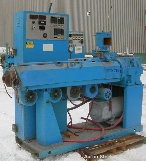 Used Akron 2 1/2" Single Screw Extruder Model PAK 250. Approximate 24:1 L/D ratio. Electrically heated, air cooled 4 zone non-vented barrel. Water cooled feed throat, no hopper. Driven by a 40 hp, 50...