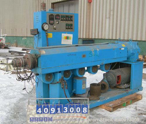 Used Akron 3 1/2" Single Screw Extruder, model PAK350. Approximate 24:1 L/D ratio.  Electrically heated, air cooled 5 zone non-vented barrel. Water cooled feed throat, no hopper. Driven by a 75 hp, 3...