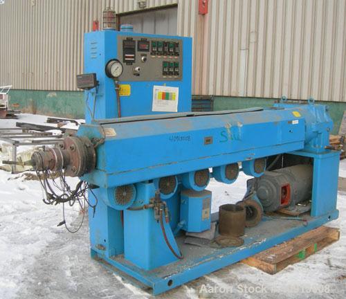 Used Akron 3 1/2" Single Screw Extruder, model PAK350. Approximate 24:1 L/D ratio.  Electrically heated, air cooled 5 zone non-vented barrel. Water cooled feed throat, no hopper. Driven by a 75 hp, 3...