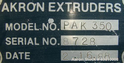 Used Akron 3 1/2" Single Screw Extruder, model PAK350. Approximate 24:1 L/D ratio.  Electrically heated, air cooled 5 zone non-vented barrel. Water cooled feed throat, no hopper. Driven by a 75 hp, 3...