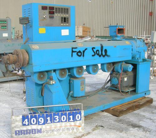 Used Akron 3 1/2" Single Screw Extruder, model PAK350, approximate 24:1 L/D ratio. Electrically heated, air cooled 5 zone non-vented barrel. Water cooled feed throat, no hopper. Driven by a 75 hp, 30...