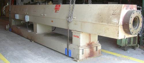 Used Hartig 10" Single Screw Extruder. Approximately 33:1 L/D ratio. Electrically heated, water cooled non-vented barrel. Feed throat, no hopper. Unit includes a Wilson model D4545 gearbox, rated at ...