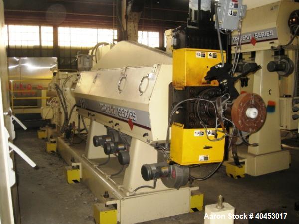 Used PTI model 5000 Trident series 5", 28:1 extruder having a 5-zone electrically heated, air cooled barrel at approximately a 55" centerline height. Gearbox is a Flenders type SZNF-320, has a reduct...