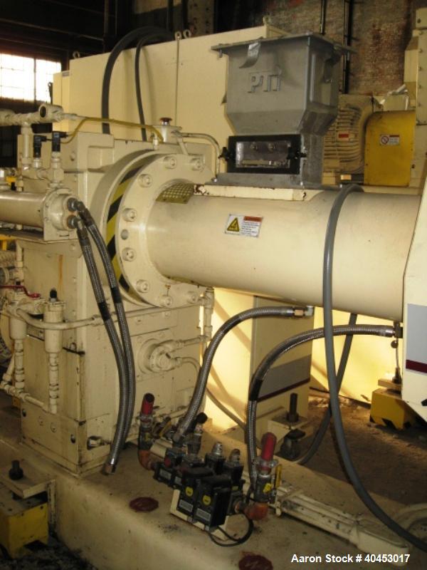 Used PTI model 5000 Trident series 5", 28:1 extruder having a 5-zone electrically heated, air cooled barrel at approximately a 55" centerline height. Gearbox is a Flenders type SZNF-320, has a reduct...
