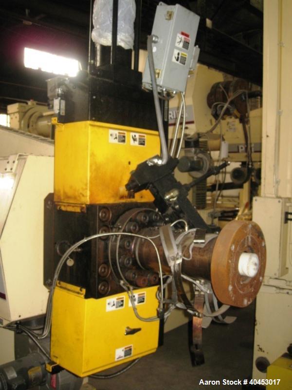 Used PTI model 5000 Trident series 5", 28:1 extruder having a 5-zone electrically heated, air cooled barrel at approximately a 55" centerline height. Gearbox is a Flenders type SZNF-320, has a reduct...