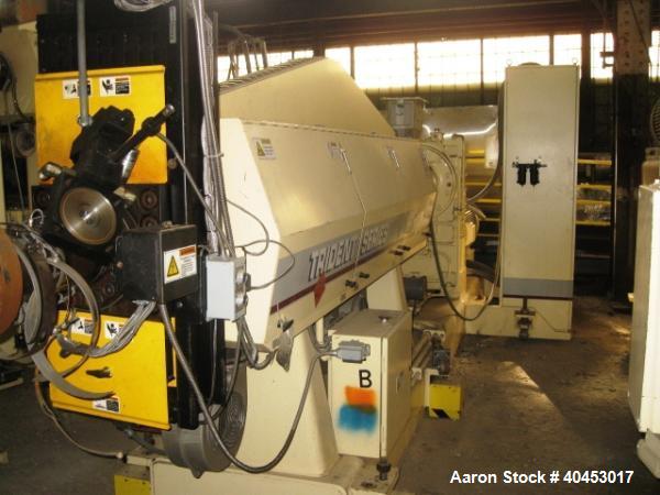 Used PTI model 5000 Trident series 5", 28:1 extruder having a 5-zone electrically heated, air cooled barrel at approximately a 55" centerline height. Gearbox is a Flenders type SZNF-320, has a reduct...