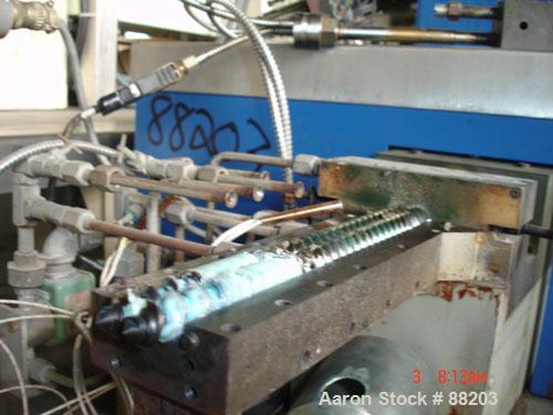 USED: APV 15MM lab size twin screw extruder, model MP2015. Co-rotating screw design. Electrically heated, water cooled barrel. Feed hopper with an accurate feeder. Driven by a 3/4 hp, 90 volt, 1725 r...