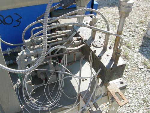 USED: APV 15MM lab size twin screw extruder, model MP2015. Co-rotating screw design. Electrically heated, water cooled barrel. Feed hopper with an accurate feeder. Driven by a 3/4 hp, 90 volt, 1725 r...