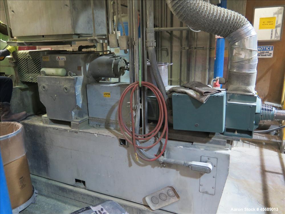 Used APV Baker Perkins 80mm Twin Screw Extruder, Model MP 2080.  DC Motor 150HP.  New PIV gearbox.  Includes; Schenck Accurate 902M Series Feeder, Steel Belt Systems Cooling Belt, Controls and Drive ...