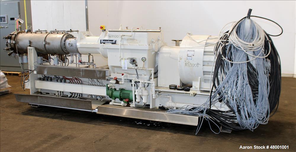 Used Berstorff 75mm Twin Screw Extruder, Model ZE75A. 4 barrel Zone electrically heated, water cooled system including pump and heat exchanger. Approximate 2.95" diameter  approx. 16:1 L/D Ratio,wate...