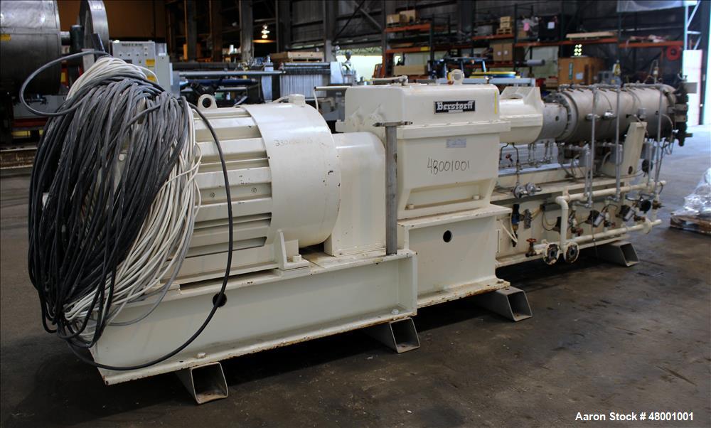 Used Berstorff 75mm Twin Screw Extruder, Model ZE75A. 4 barrel Zone electrically heated, water cooled system including pump and heat exchanger. Approximate 2.95" diameter  approx. 16:1 L/D Ratio,wate...
