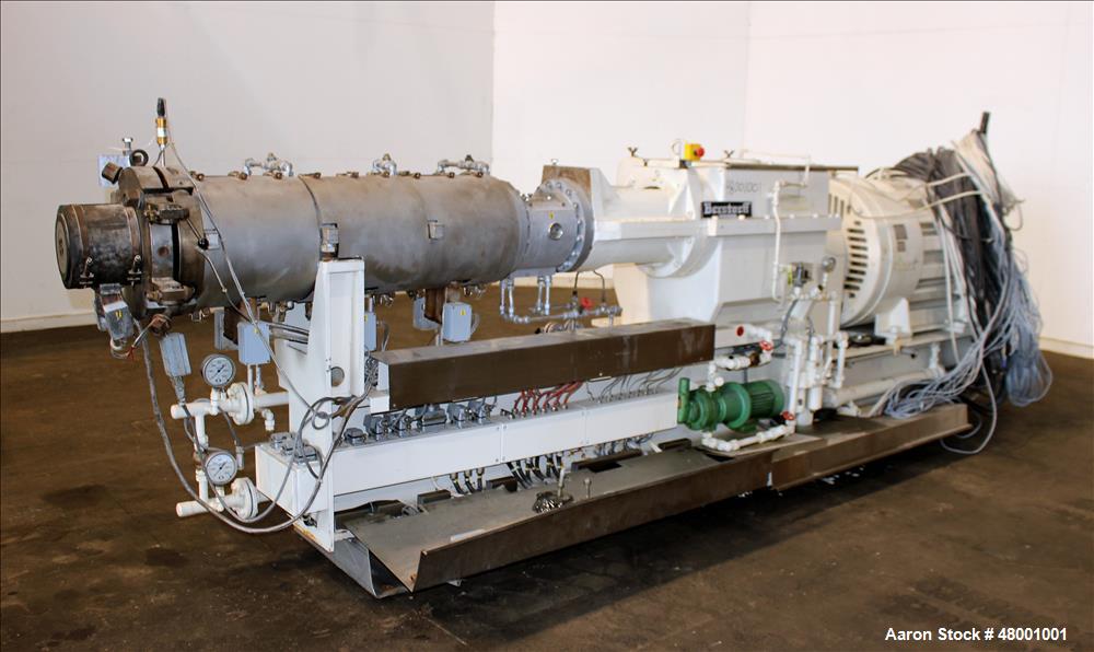 Used Berstorff 75mm Twin Screw Extruder, Model ZE75A. 4 barrel Zone electrically heated, water cooled system including pump and heat exchanger. Approximate 2.95" diameter  approx. 16:1 L/D Ratio,wate...