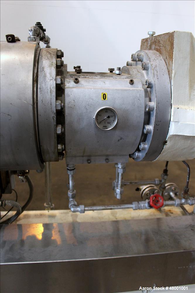 Used Berstorff 75mm Twin Screw Extruder, Model ZE75A. 4 barrel Zone electrically heated, water cooled system including pump and heat exchanger. Approximate 2.95" diameter  approx. 16:1 L/D Ratio,wate...