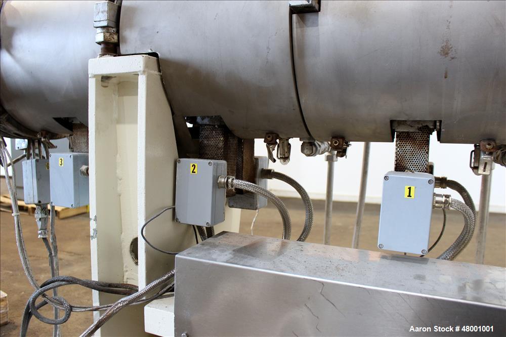 Used Berstorff 75mm Twin Screw Extruder, Model ZE75A. 4 barrel Zone electrically heated, water cooled system including pump and heat exchanger. Approximate 2.95" diameter  approx. 16:1 L/D Ratio,wate...