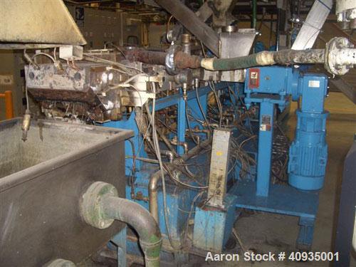 Used Twin Screw Extruder, 83 mm, 10 Barrels. Electrically heated and water cooled. 200 hp DC/SCR drive. Complete temp control panel. (1) ZSB 70 side feeder. Mfg 2004. Multi hole strand die.
