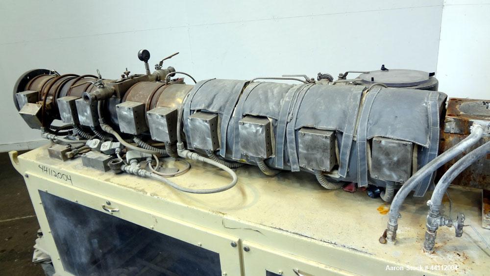 Used American Maplan 88mm Counter-Rotating Twin Screw Extruder, Model TS-88. Approximate 24 to 1 L/D ratio. (10) barrel zones, (1) section top vented, Electrically heated, liquid cooled. No screws. W...