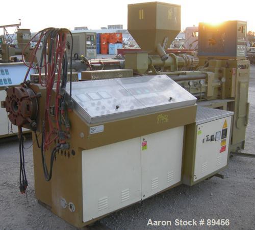 USED: Amut twin screw extruder, 92 mm screw diameter, model BA92. Approximate 22:1 L/D ratio. Counter-rotating screw design. 5 zone top vented, electrically heated, air cooled barrel with vacuum pump...