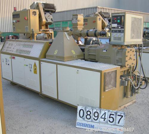 USED: Amut twin screw extruder, 92 mm screw diameter, model BA92. Approximate 24:1 L/D ratio. Counter-rotating screw design. 6 zone top vented, electrically heated, air cooled barrel with vacuum pump...