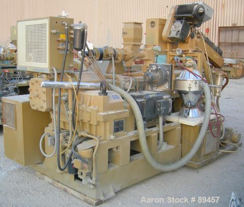 USED: Amut twin screw extruder, 92 mm screw diameter, model BA92. Approximate 24:1 L/D ratio. Counter-rotating screw design. 6 zone top vented, electrically heated, air cooled barrel with vacuum pump...
