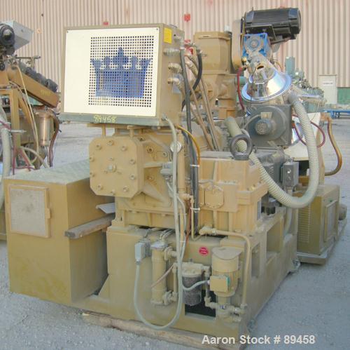 USED: Amut twin screw extruder, 92 mm screw diameter, model BA92. Approximate 24:1 L/D ratio. Counter-rotating screw design. 6 zone top vented, electrically heated, air cooled barrel with vacuum pump...