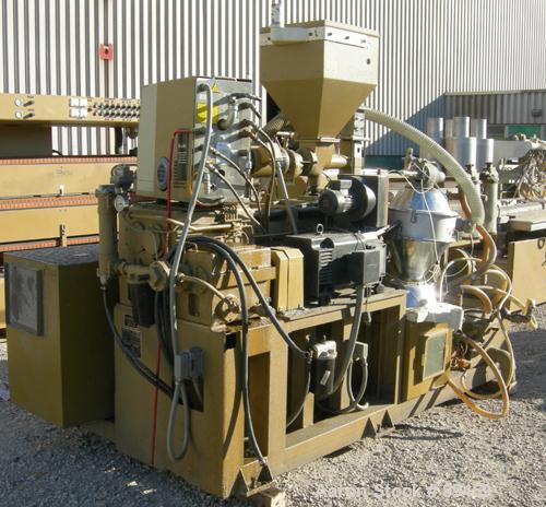 USED: Amut twin screw extruder, 92 mm screw diameter, model BA92. Approximate 24:1 L/D ratio, counter rotating screw design, 6 zone top vented electrically heated, air cooled barrel with vacuum pump....