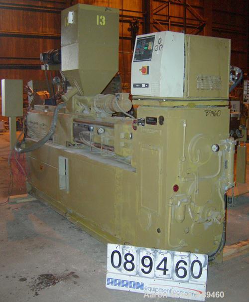 USED: Amut twin screw extruder, 92 mm screw diameter, model BA92. Approximate 22:1 L/D ratio. Counter-rotating screw design. 5 zone top vented, electrically heated, air cooled barrel with vacuum pump...