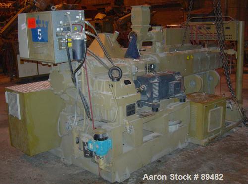 USED: Amut twin screw extruder, 92 mm screw diameter, model BA92. Approximate 22:1 L/D ratio. Counter-rotating screw design. 5 zone top vented, electrically heated, air cooled barrel with vacuum pump...