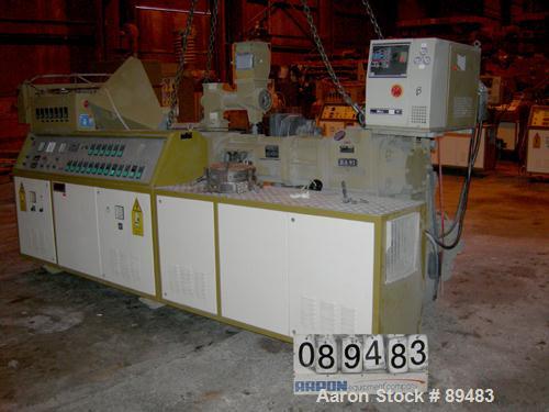 USED: Amut twin screw extruder, 92 mm screw diameter, model BA92. Approximate 22:1 L/D ratio. Counter-rotating screw design. 5 zone top vented, electrically heated, air cooled barrel with vacuum pump...