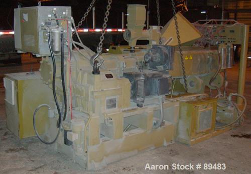 USED: Amut twin screw extruder, 92 mm screw diameter, model BA92. Approximate 22:1 L/D ratio. Counter-rotating screw design. 5 zone top vented, electrically heated, air cooled barrel with vacuum pump...