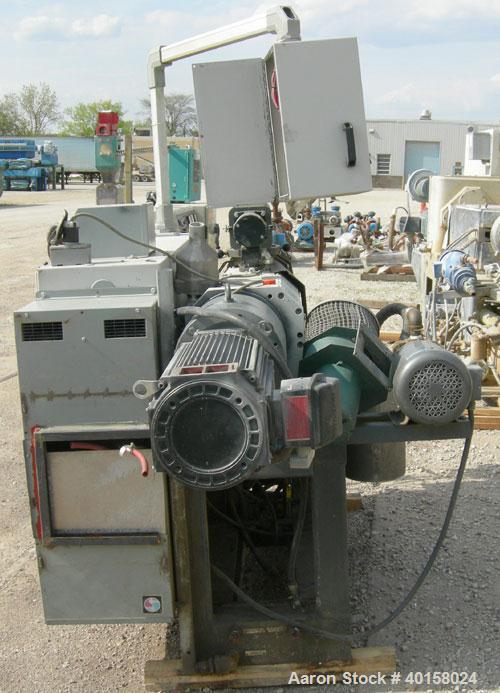 Used Cincinnati Milacron model CM35 35mm conical counter rotating twin screw extrusion equipment. New 2000. Extruder serial #E50A0200003. Has 8 zone temperature control panel utilizing Barber Coleman...