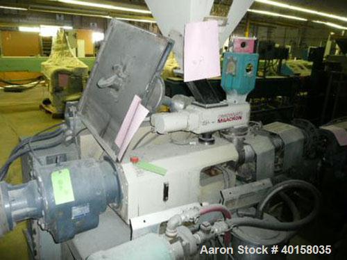 Used Cincinnati Milicron Conical Counter-Rotating Twin Screw Extruder, 35 mm, model CM35. Electrically heated, water cooled vented barrel with pump. Water cooled feed throat with a dosing feeder. App...