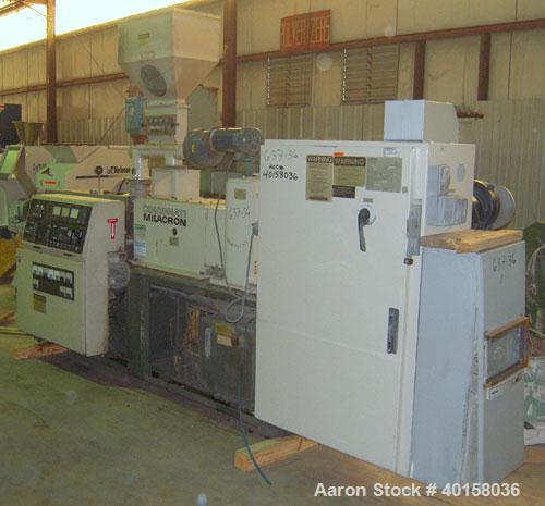 Used Cincinnati Milicron Conical Counter-Rotating Twin Screw Extruder, 55 mm, model CM55HP. Electrically heated, water cooled vented barrel with pump. Water cooled feed throat with a dosing feeder. A...