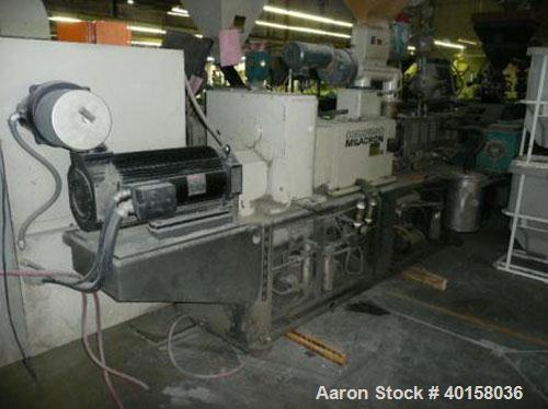 Used Cincinnati Milicron Conical Counter-Rotating Twin Screw Extruder, 55 mm, model CM55HP. Electrically heated, water cooled vented barrel with pump. Water cooled feed throat with a dosing feeder. A...