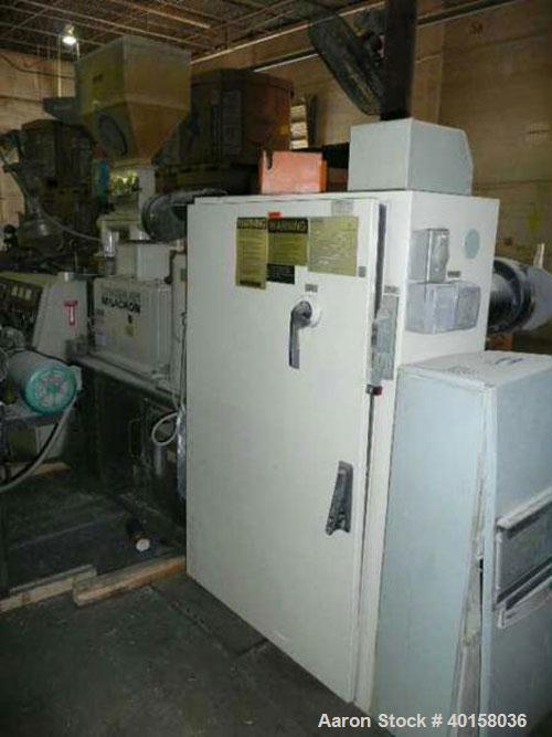 Used Cincinnati Milicron Conical Counter-Rotating Twin Screw Extruder, 55 mm, model CM55HP. Electrically heated, water cooled vented barrel with pump. Water cooled feed throat with a dosing feeder. A...